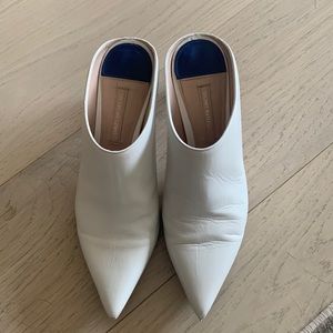 Stuart Weitzman white leather mules.